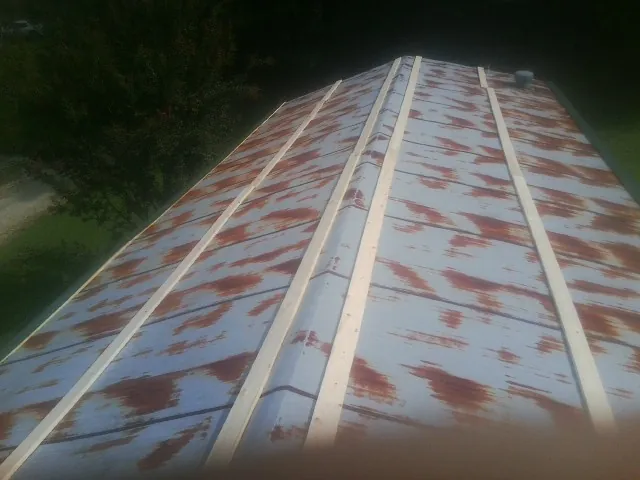 Rusted metal roof panels with new wood purlins before replacement — Storm Damage Roof Repair in Casa Blanca by Roofing Brothers